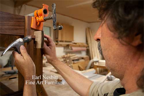 Earl tapping peg into through tenon on custom made dining table base